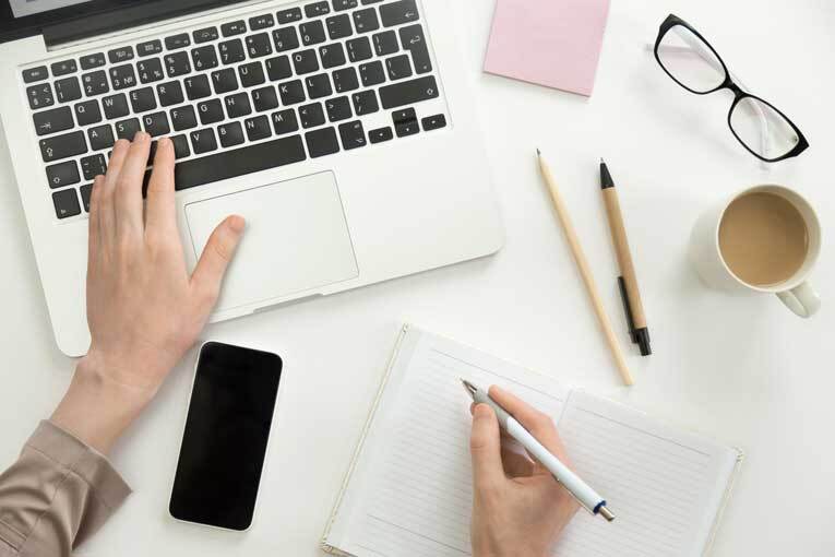 Freelance writer typing on laptop image