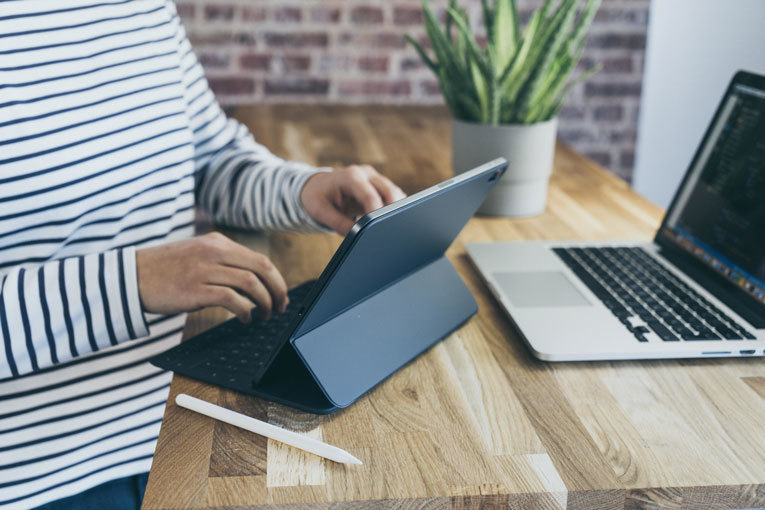 Man typing on tablet image