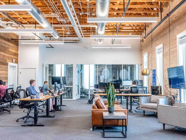 Workers sitting at desks in office image