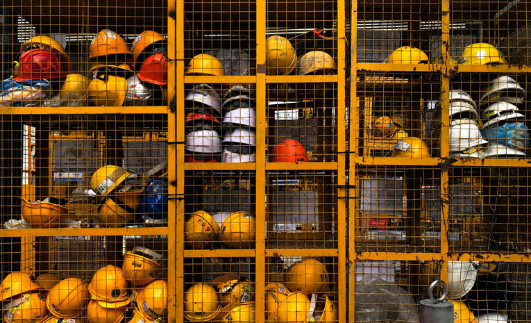 Construction helmets in cage for health and safety image