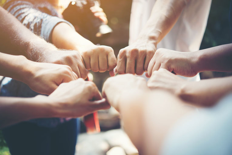 Group of people with hands together image