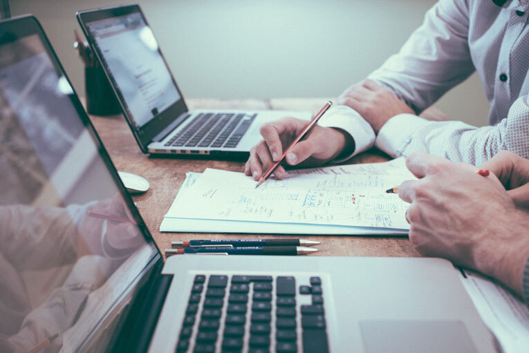 Man on laptop registering for vat with his accountant image