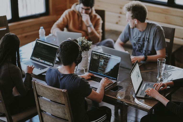 Office workers at desk on laptop image