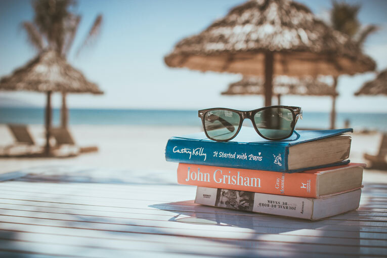 Sunglasses and books on the beach during annual leave image