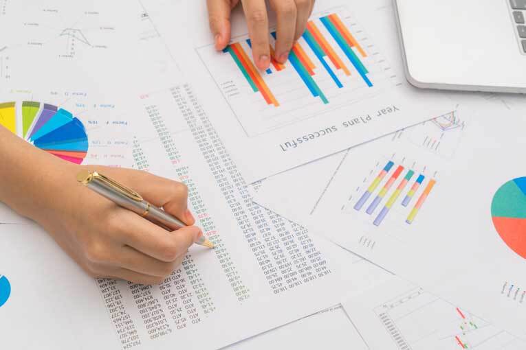 Woman calculating business profit at her desk image