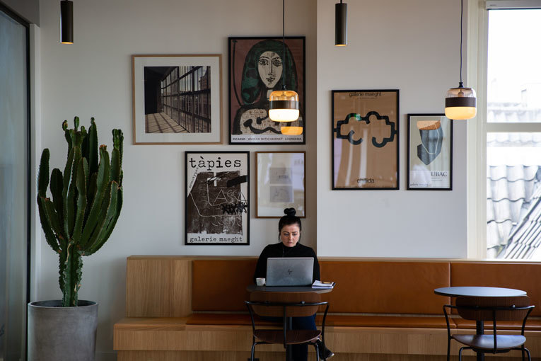 Woman with laptop sitting in cafe image